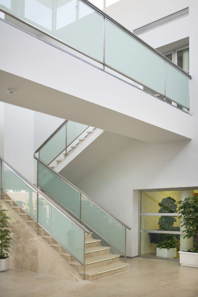 modern-building-interior-with-staircase-and-walkwa-532KJ7R.jpg